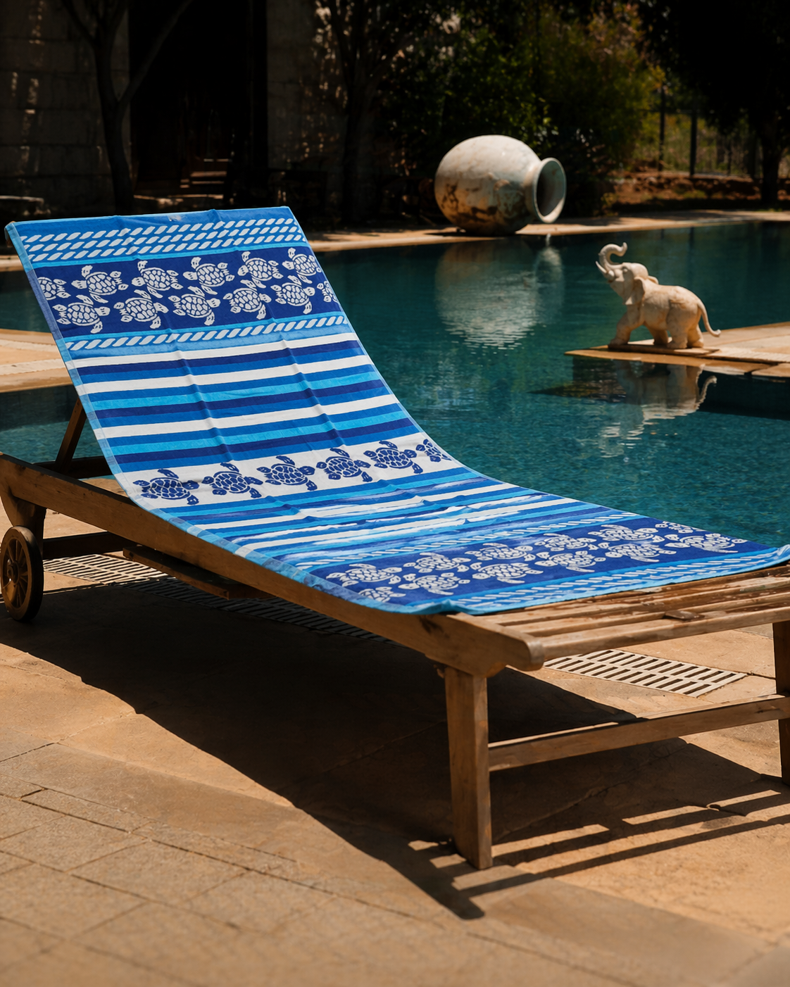 Blue and white striped beach towel with sea turtle and rope motif borders