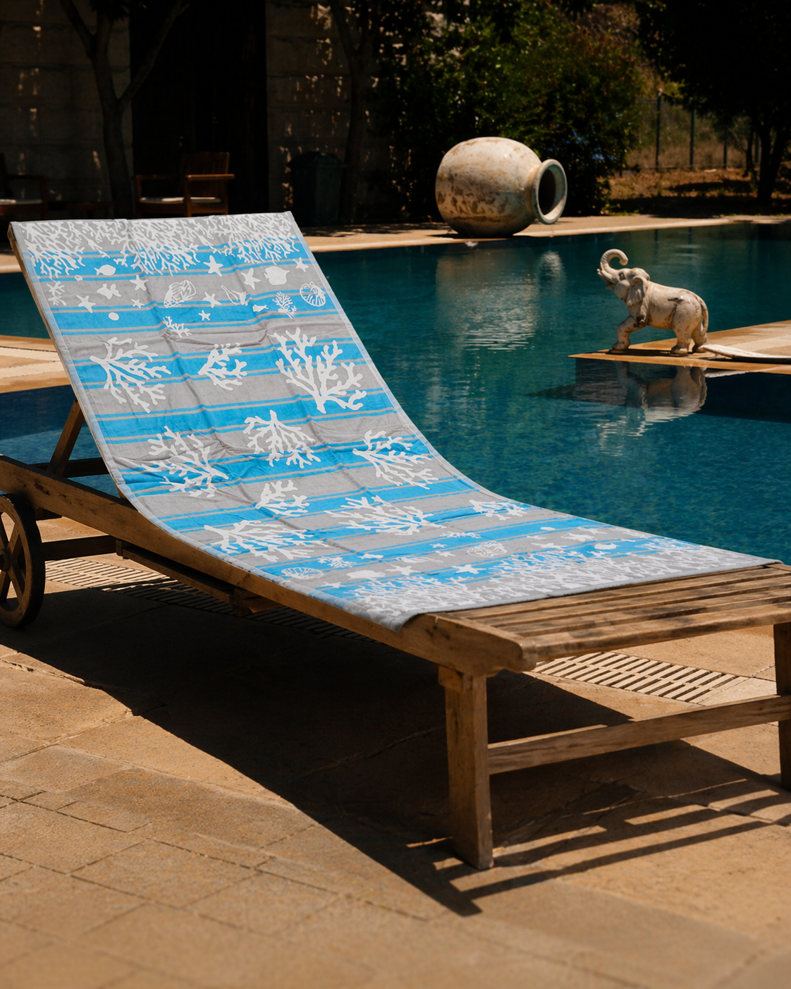 Blue and grey striped beach towel with white coral, shells and fish patterns