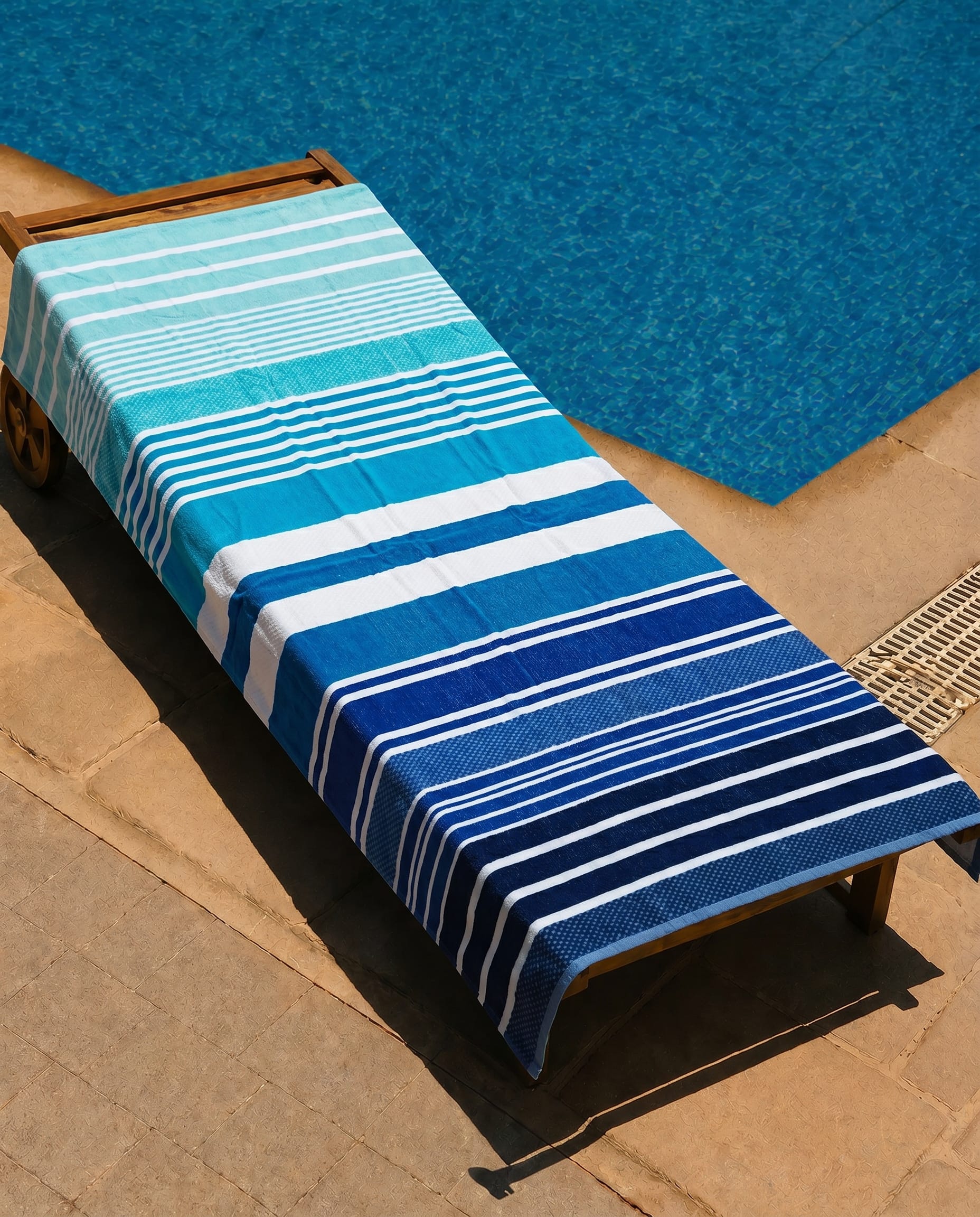 Deep Tide Beach Towel draped over a lounge chair
