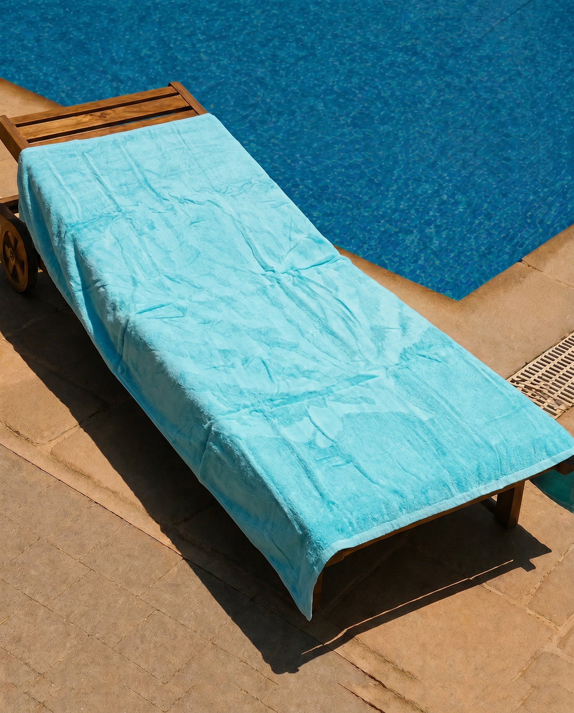 Aqua Mist Beach Towel draped over a lounge chair