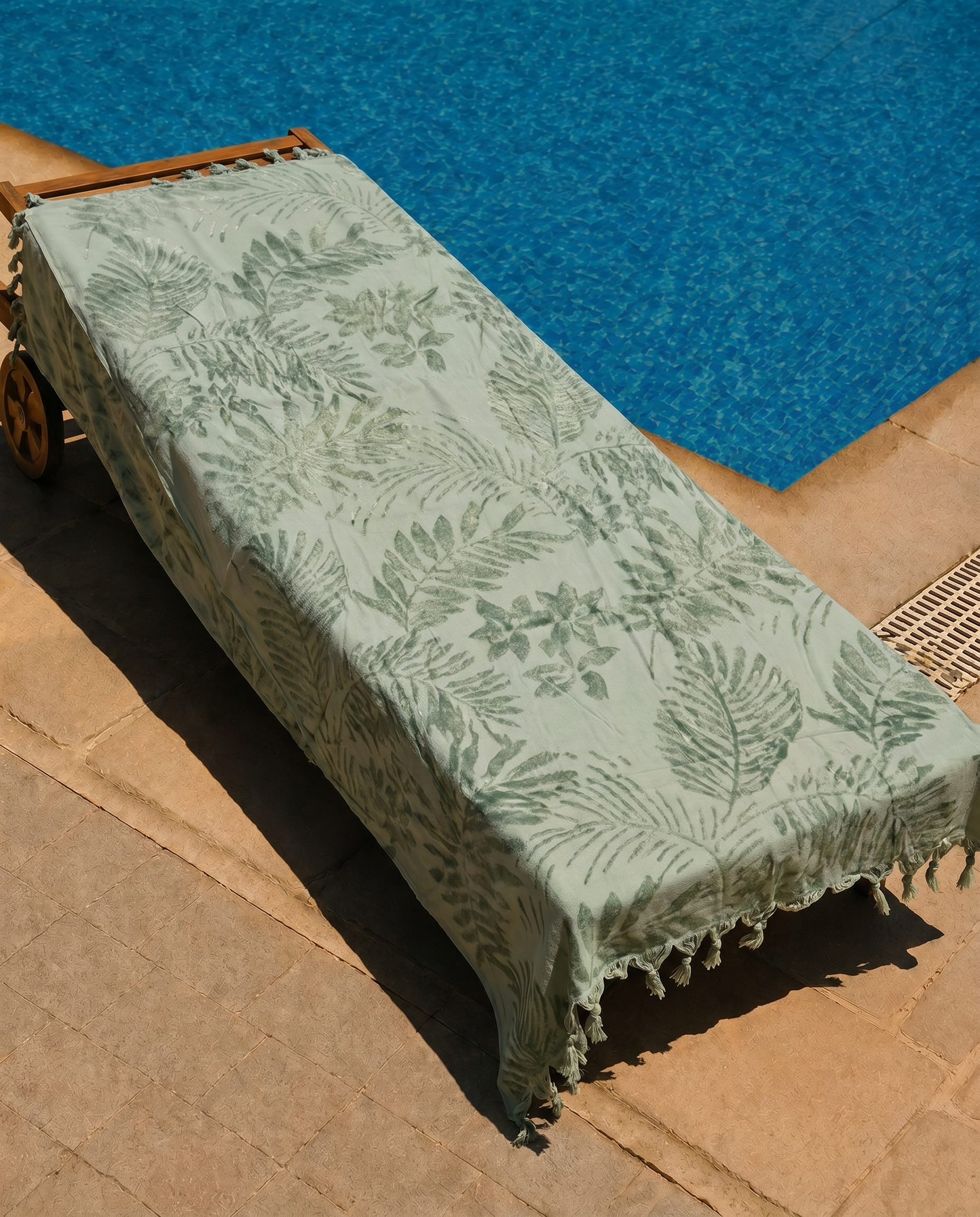 Sage Palm Beach Towel draped over a lounge chair