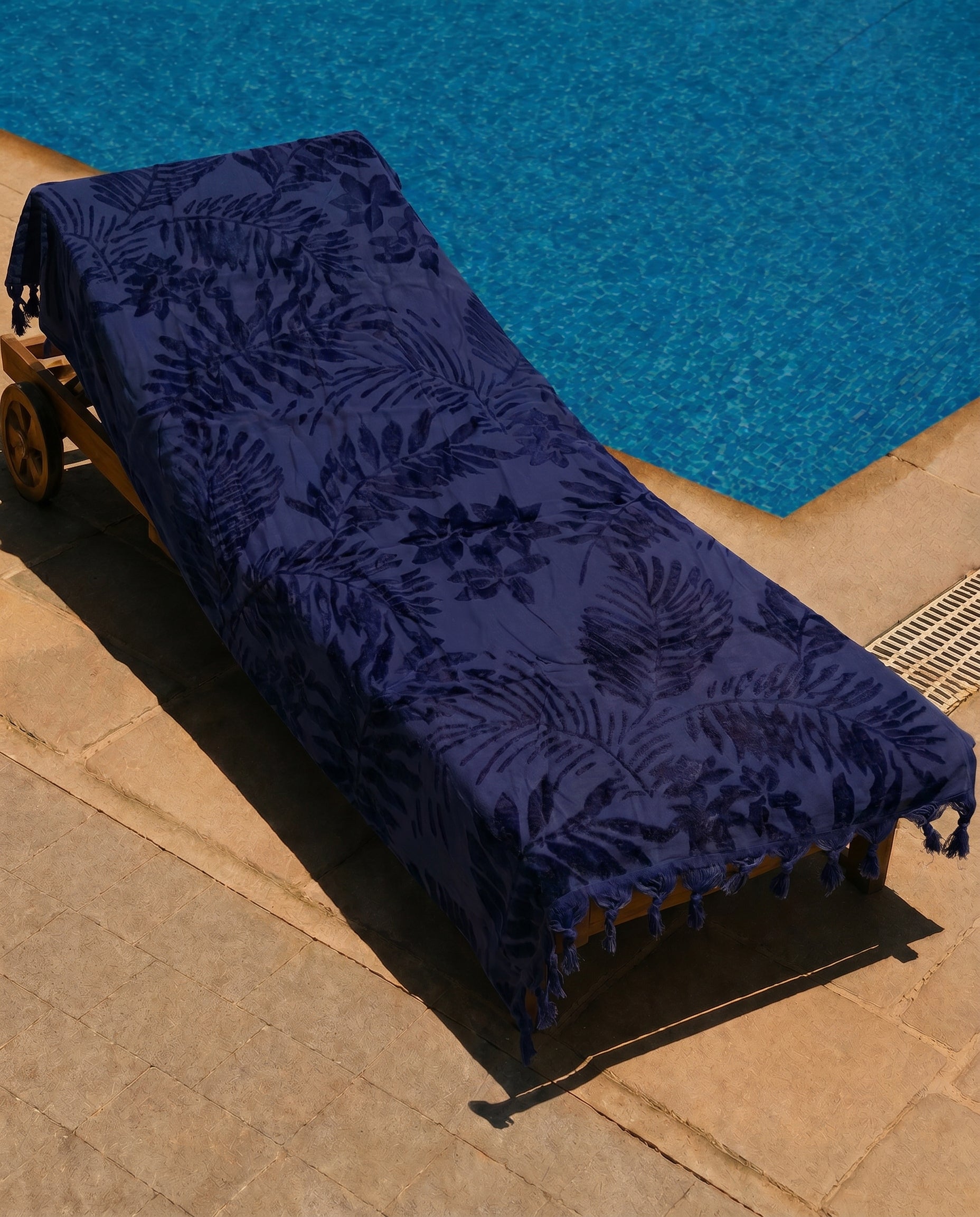 Indigo Palm Beach Towel draped over a lounge chair