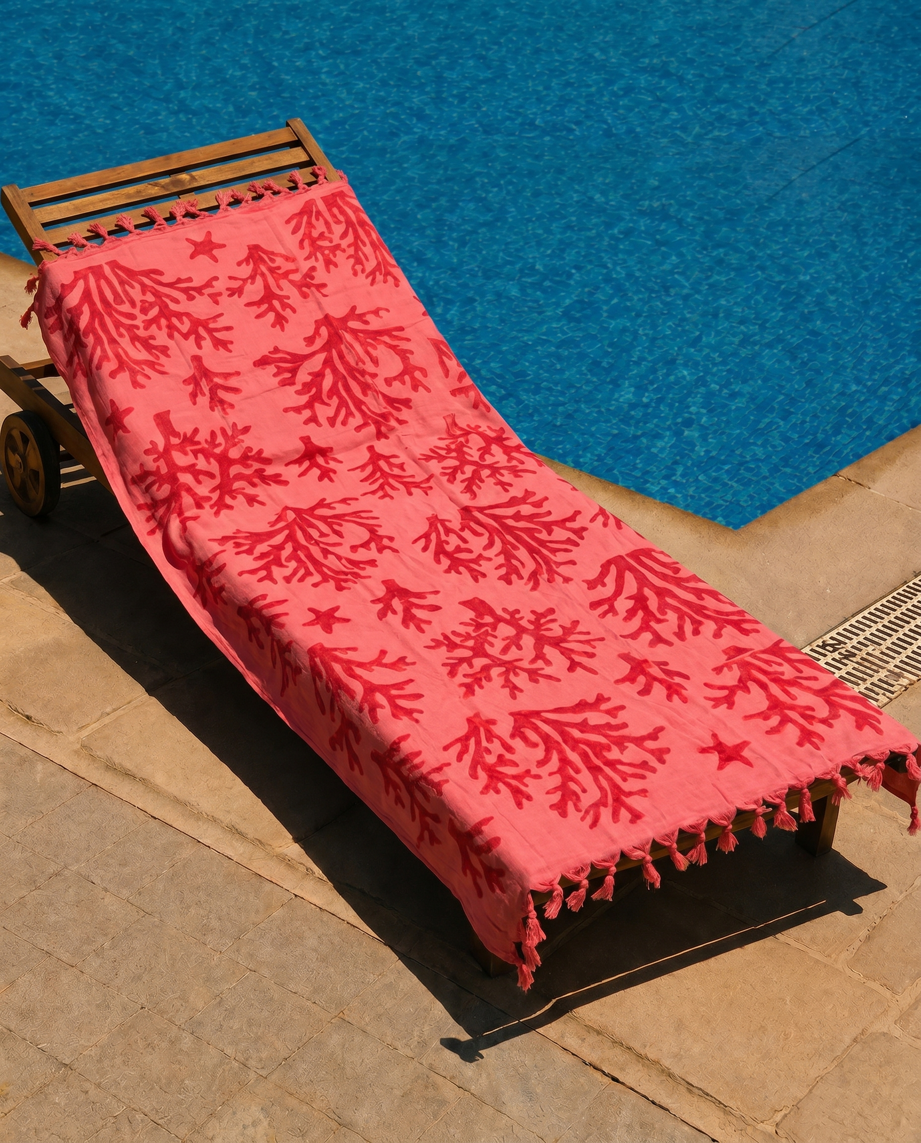 Coral Reef Beach Towel draped over a lounge chair