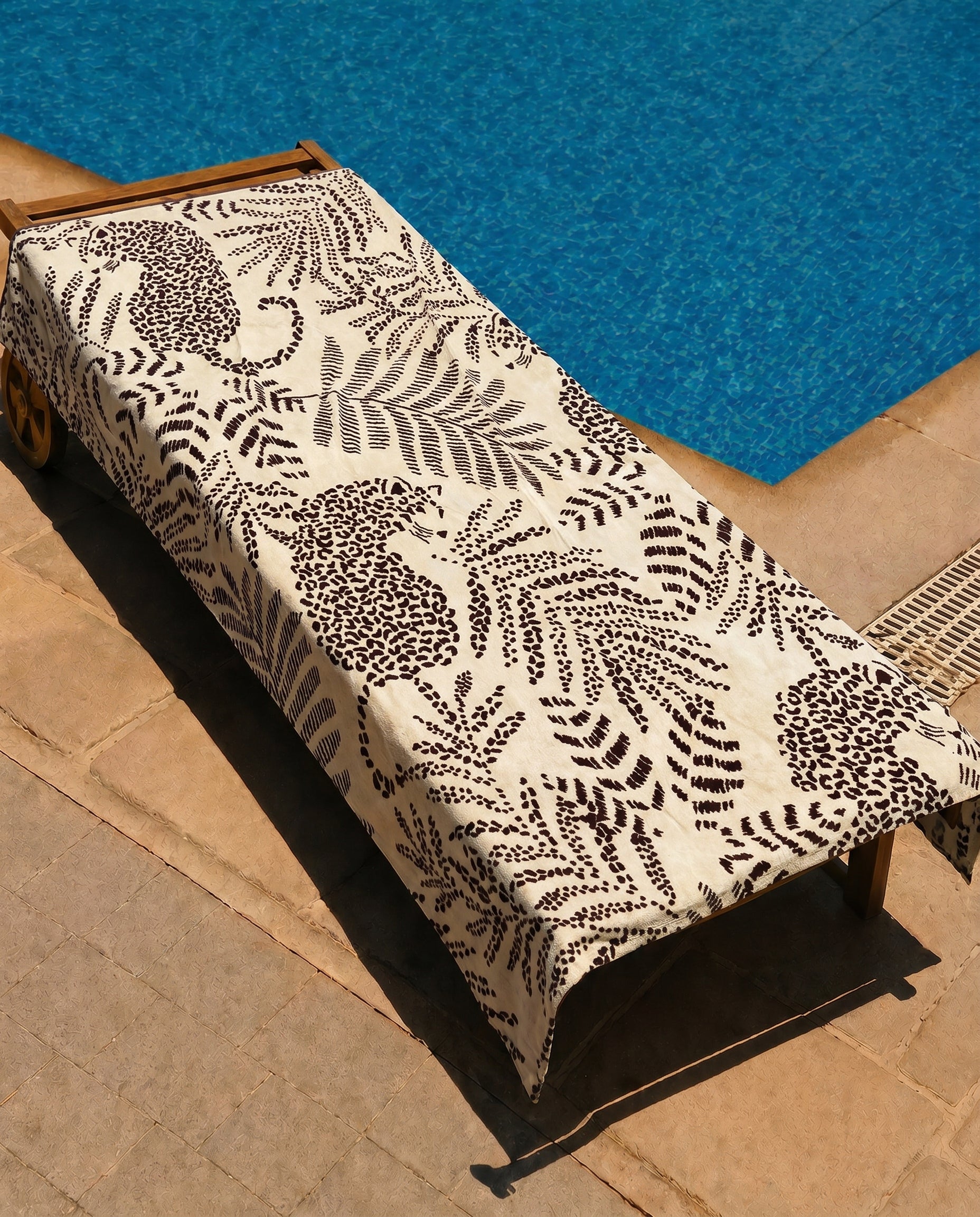 Safari Leopard Beach Towel draped over a lounge chair