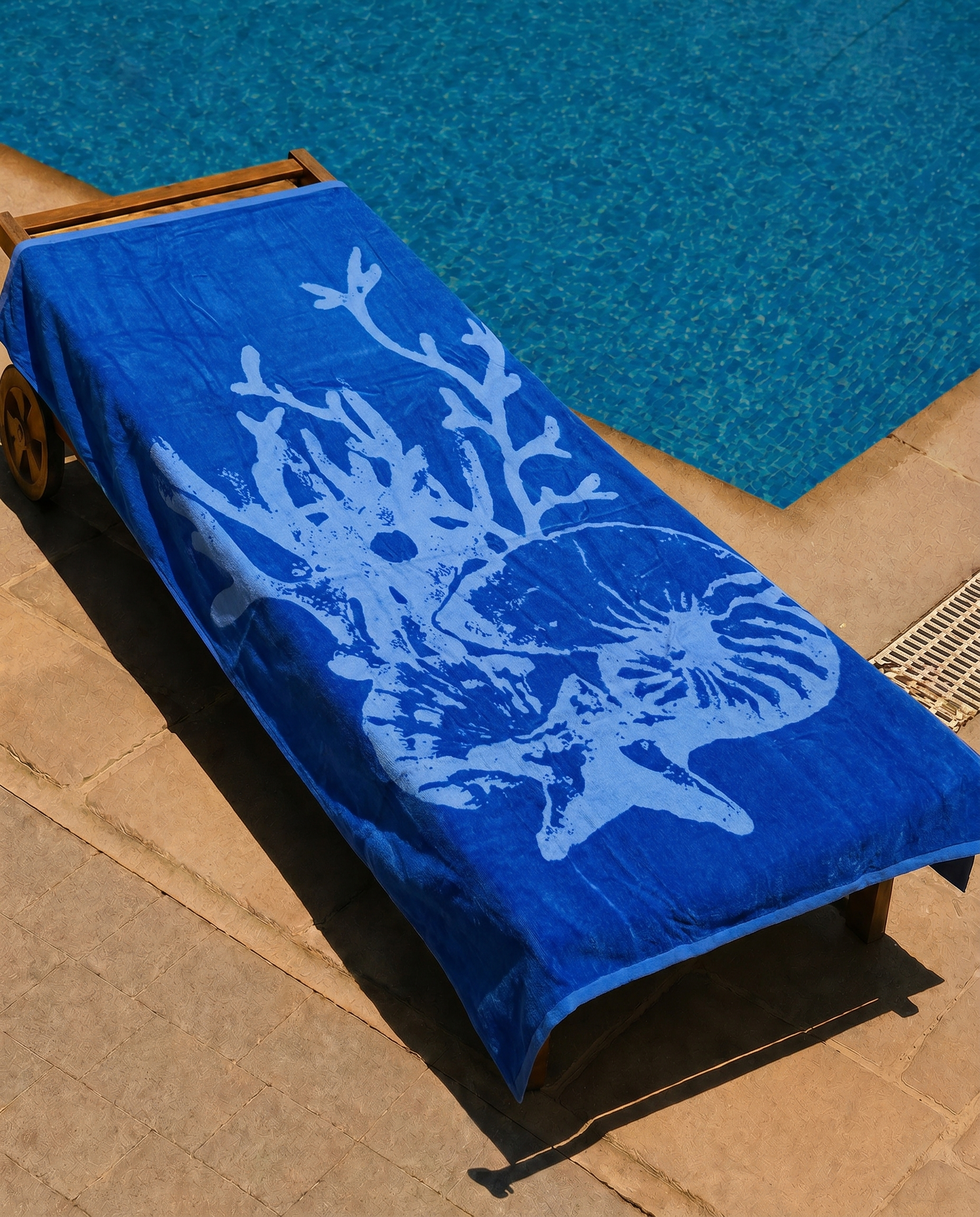 Royal Nautilus Beach Towel draped on a lounge chair
