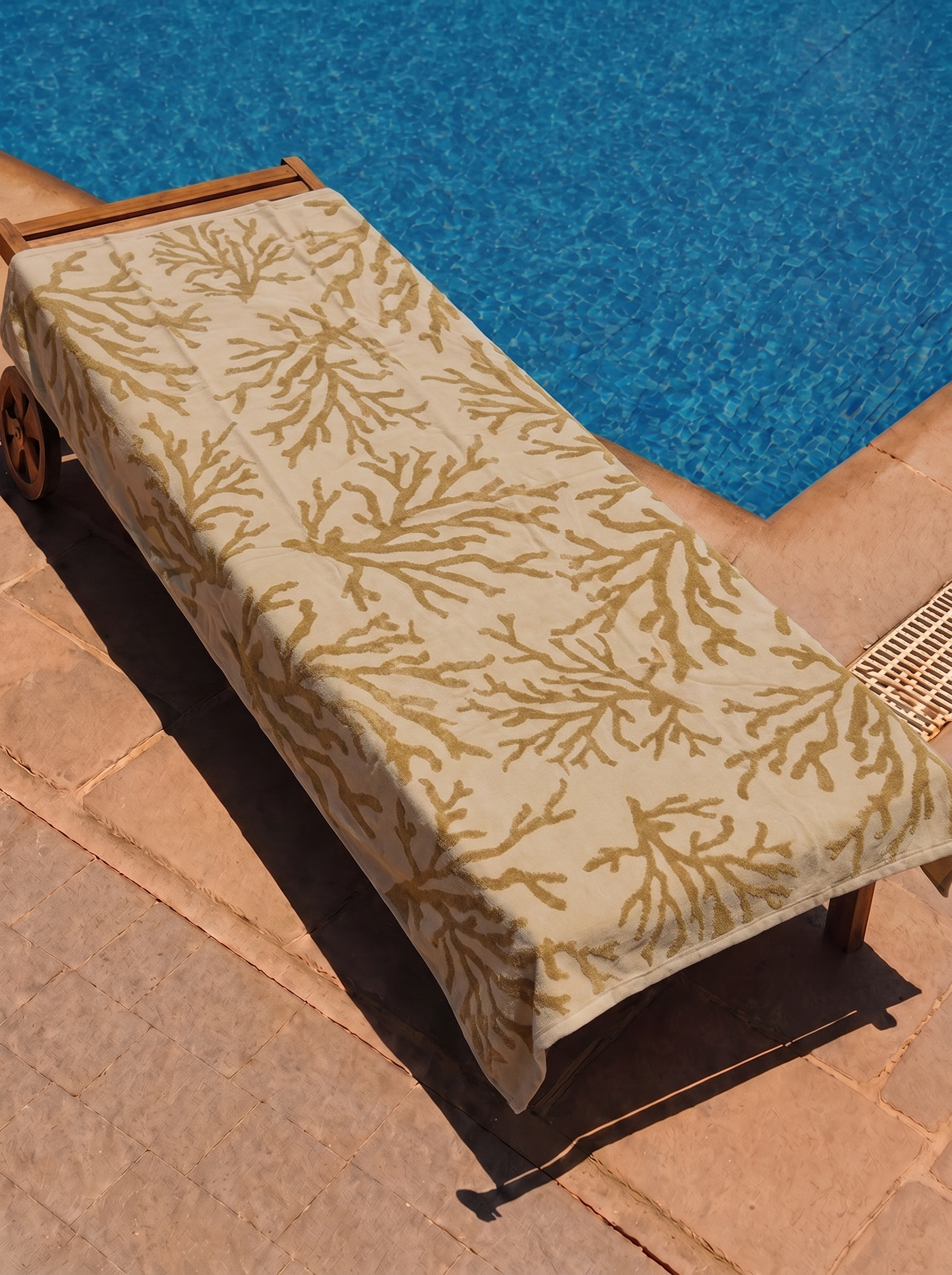 Gold Coral Branch Towel on a poolside lounge chair