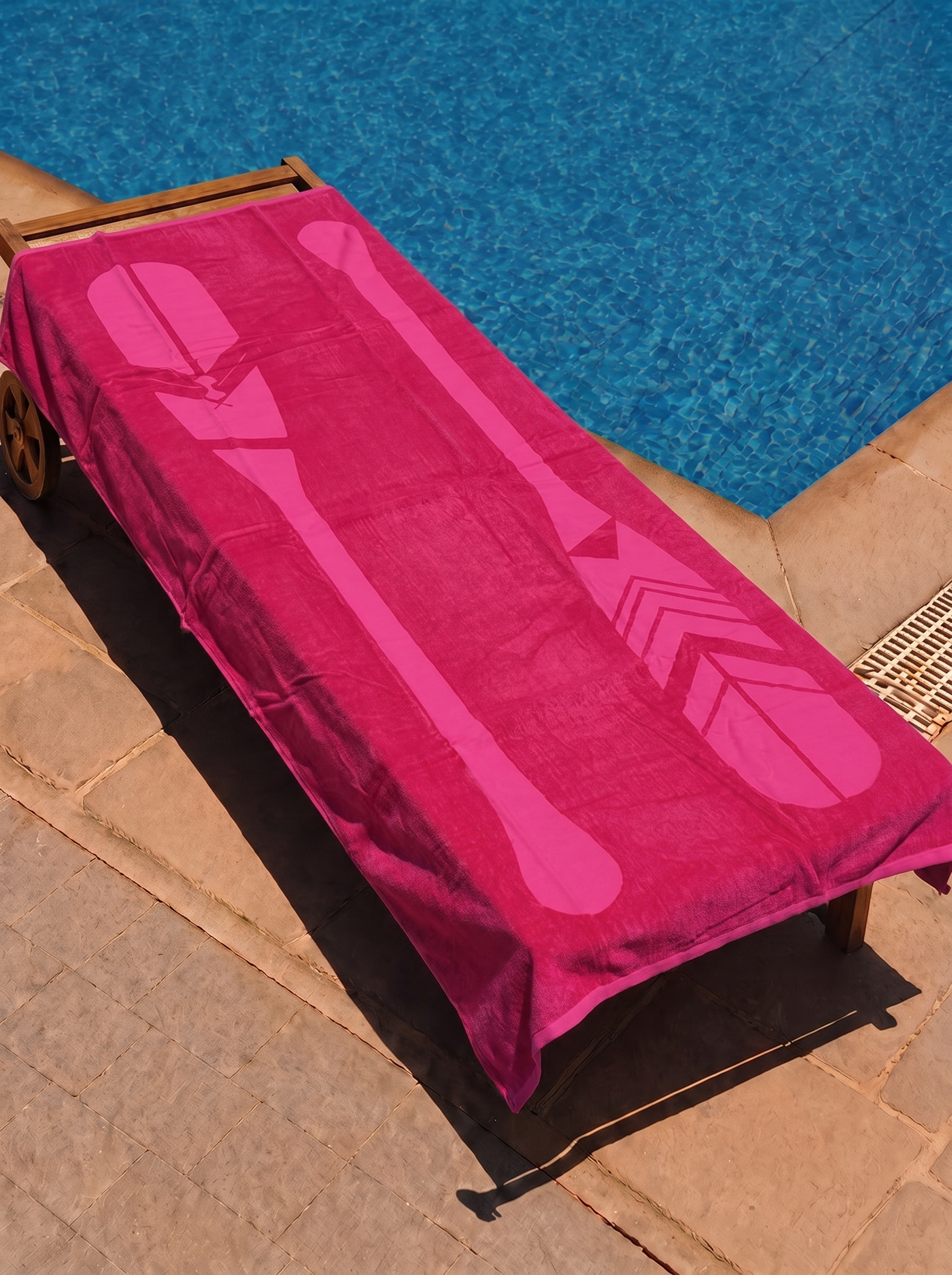 Magenta tonal paddle towel on a poolside lounge chair