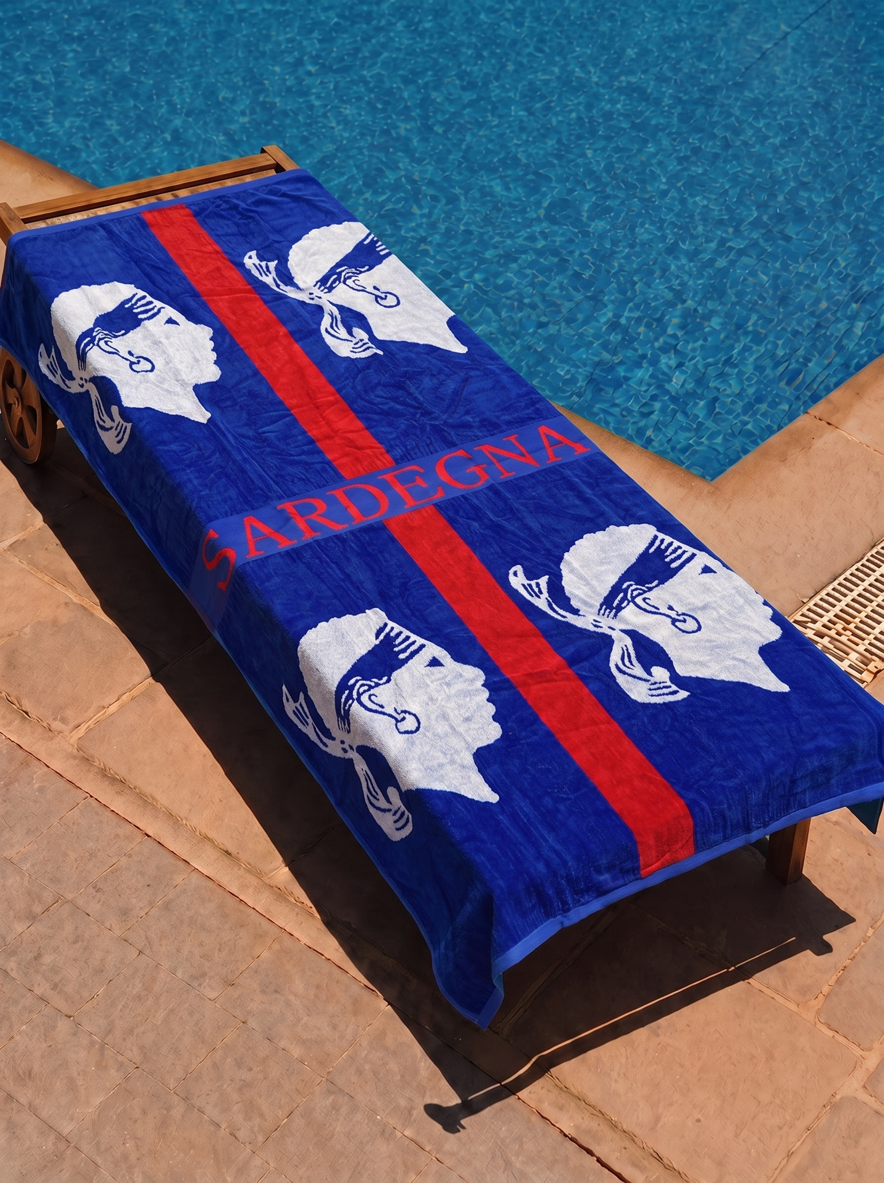 Sardegna flag towel on a poolside lounge chair