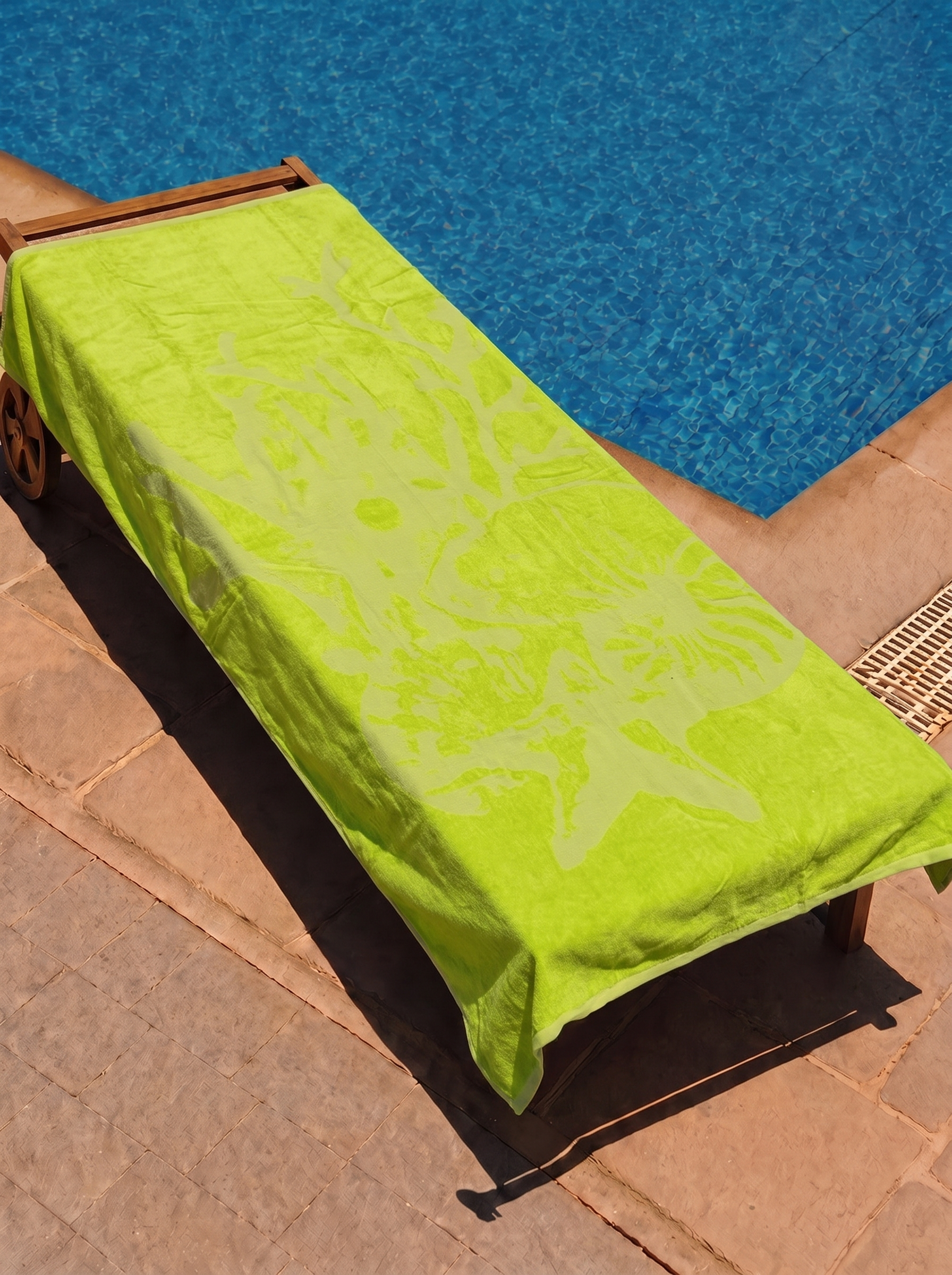 Neon lime beach towel on a poolside lounge chair