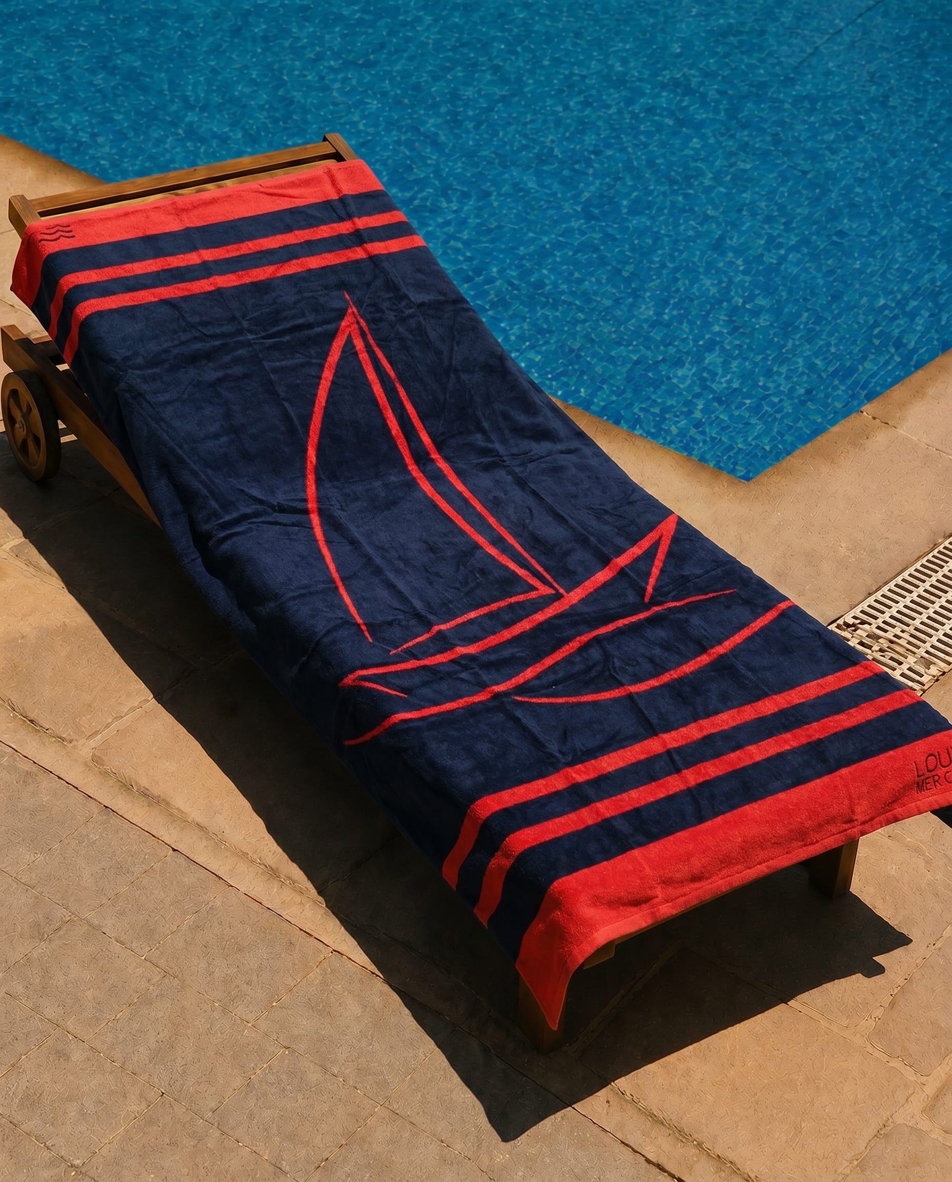 Regatta Red Beach Towel draped over a lounge chair