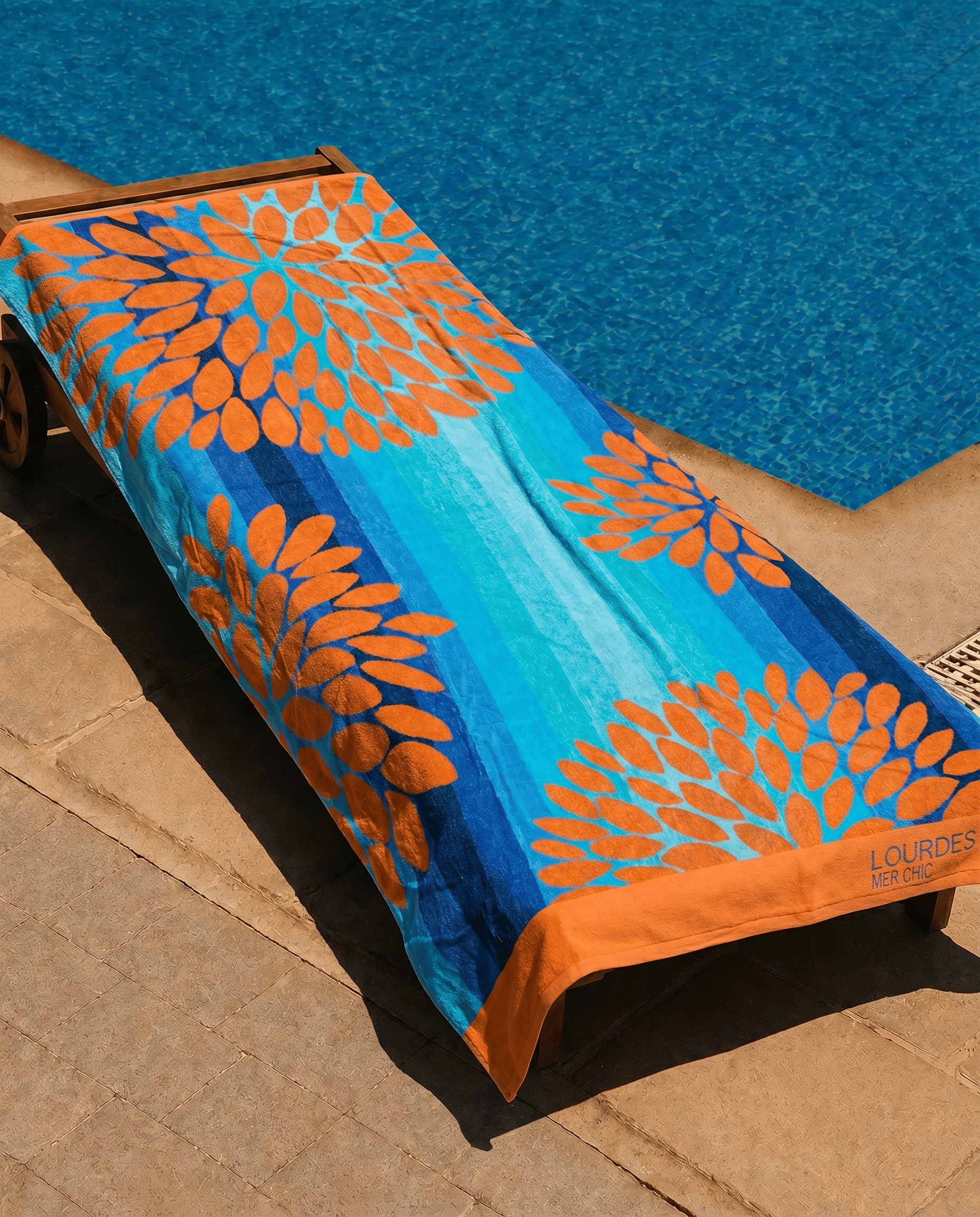 Aqua Bloom Beach Towel draped over a lounge chair