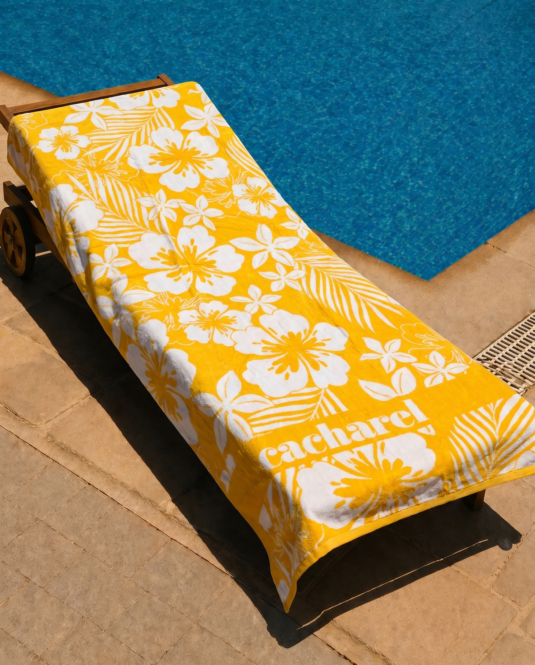 Golden Hibiscus Beach Towel draped on a lounge chair